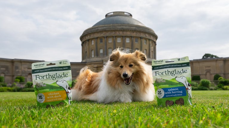 A dog on the lawn with dog treats from the Forthglade range at Ickworth House, Suffolk
